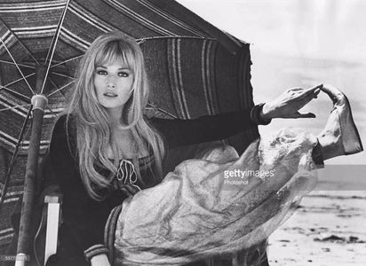 actress-monica-vitti-relaxing-under-a-parasol-as-she-film-scenes-for-picture-id557709671